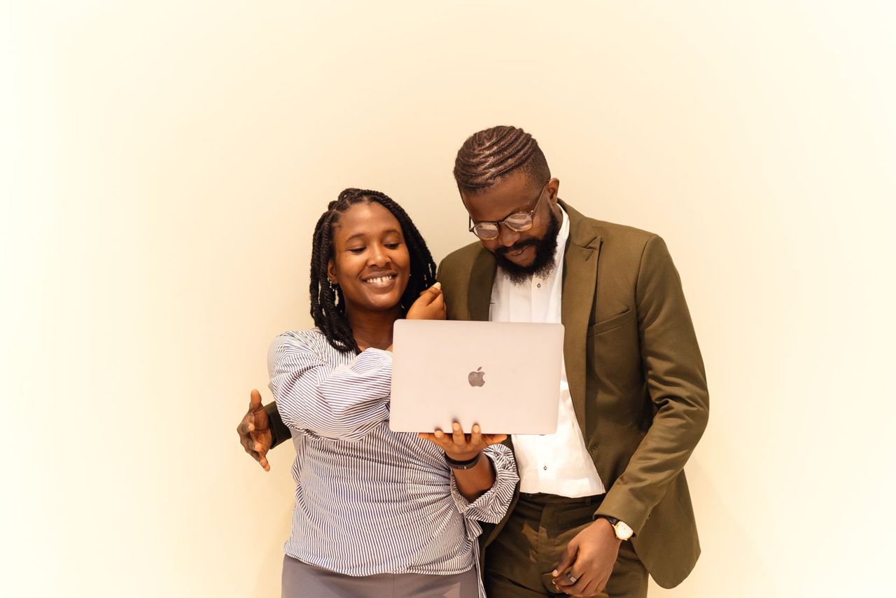 Two colleagues reviewing something together on a laptop