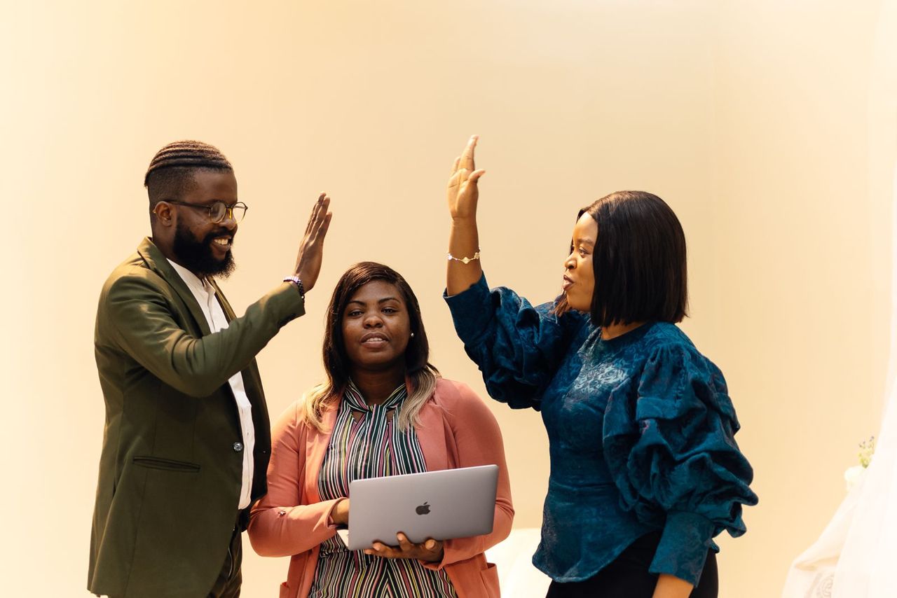 Colleagues celebrating with a high five in the office